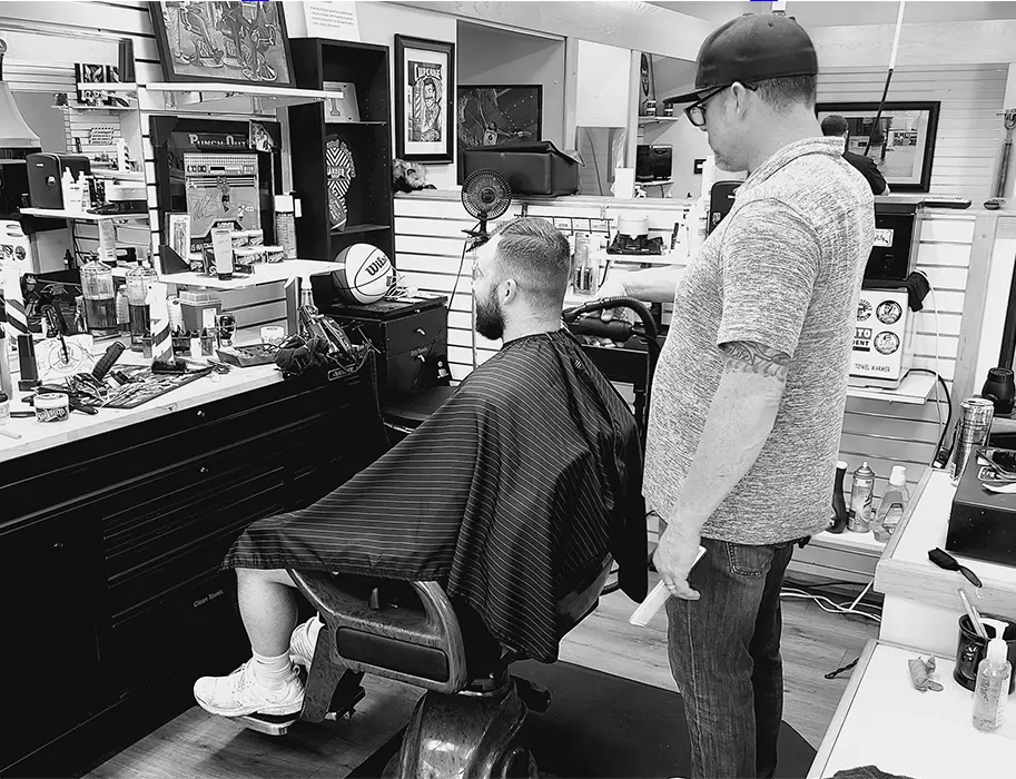 A man getting his hair cut at the barber shop