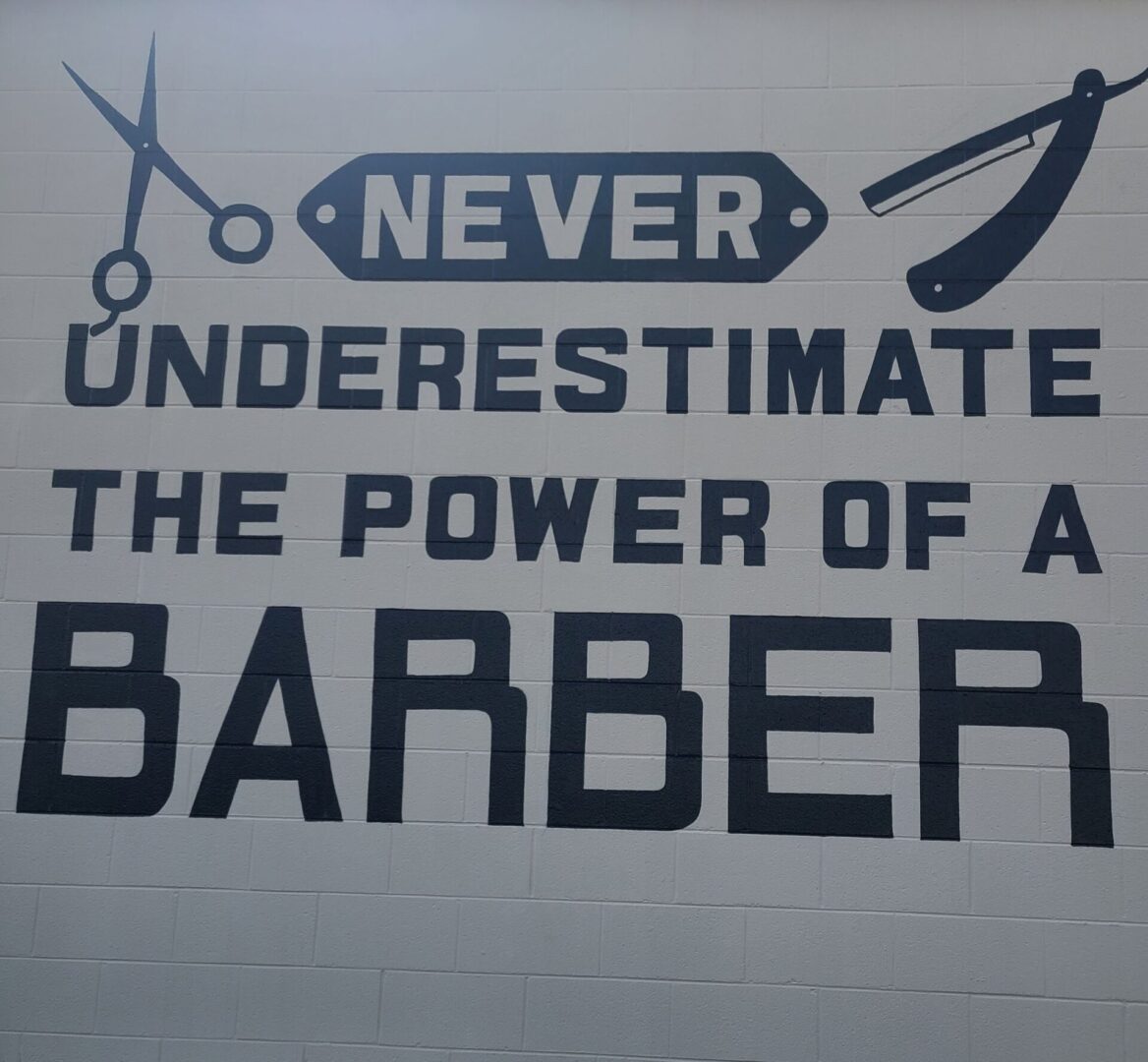 A barber shop sign with scissors and clippers.